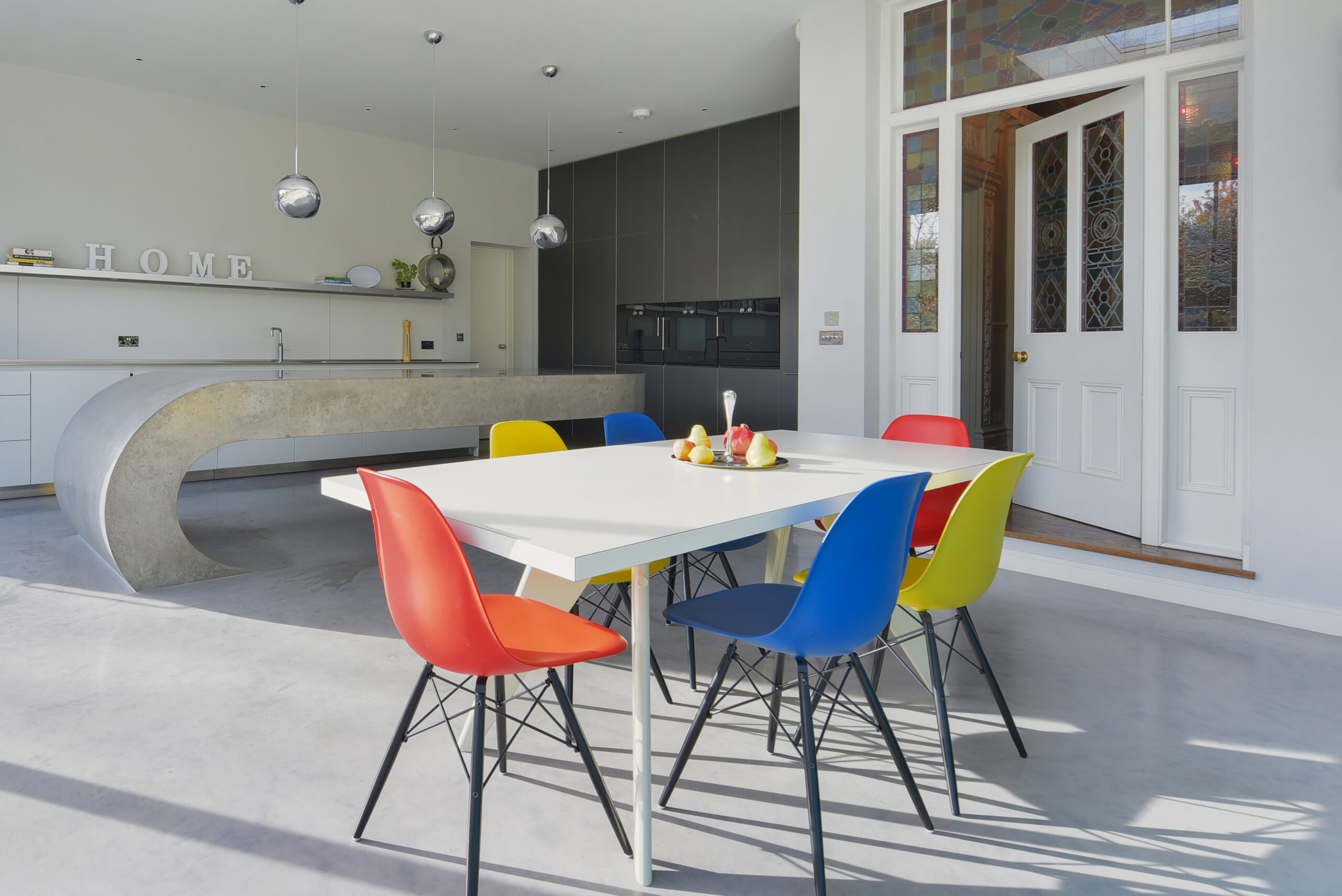 bright chairs and concrete kitchen