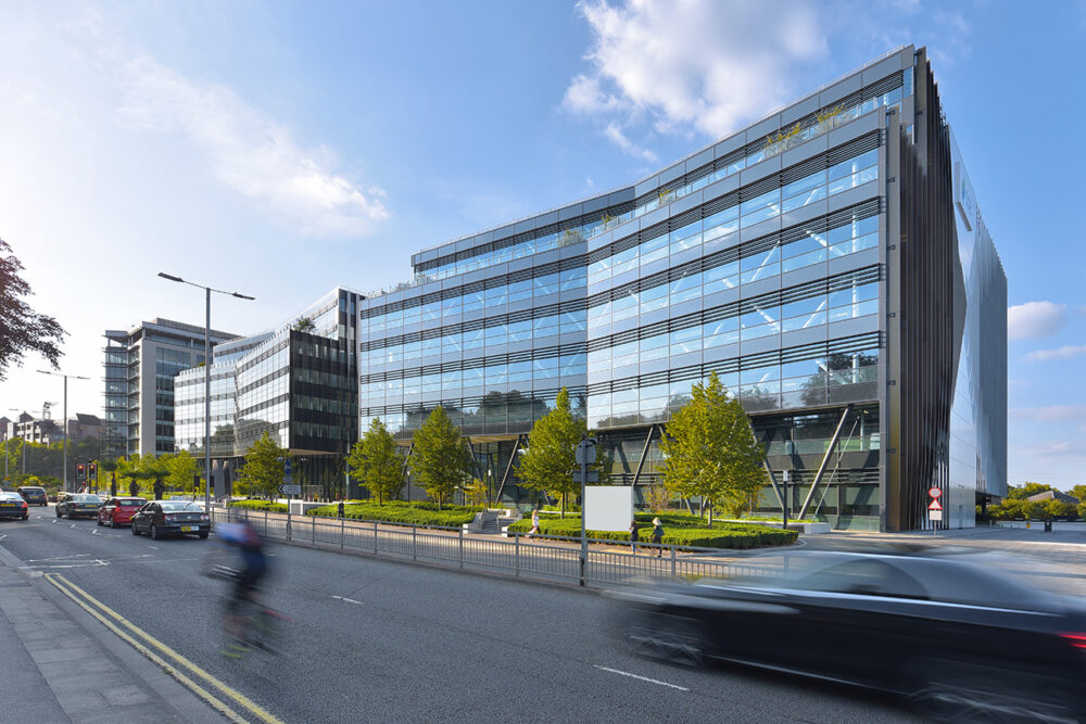 Office building photograph with car and bike passing by in Reading berkshire