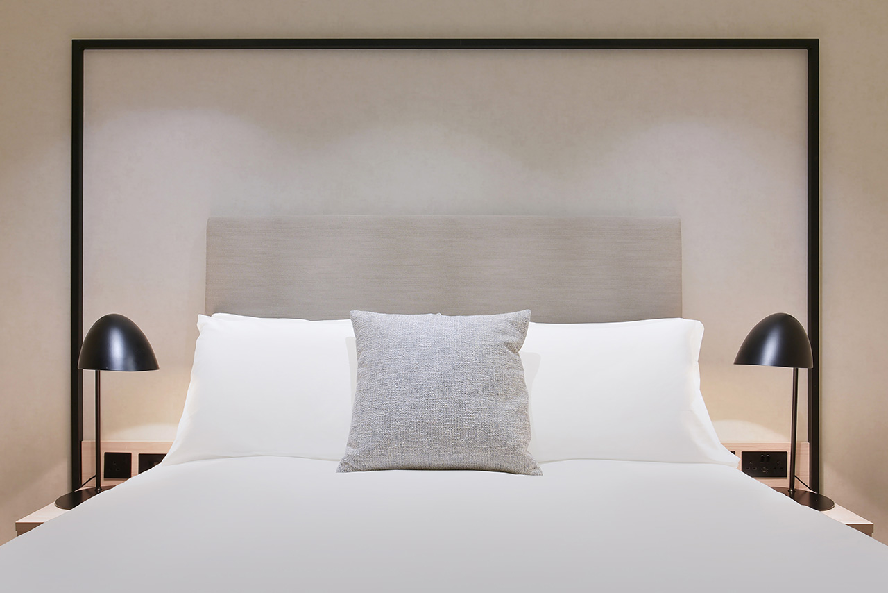 white pillows on bed hotel interior photography