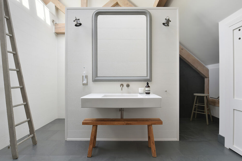 stunning white modern bathroom with wooden ladder photographed by London based Architectural Interior Photographer