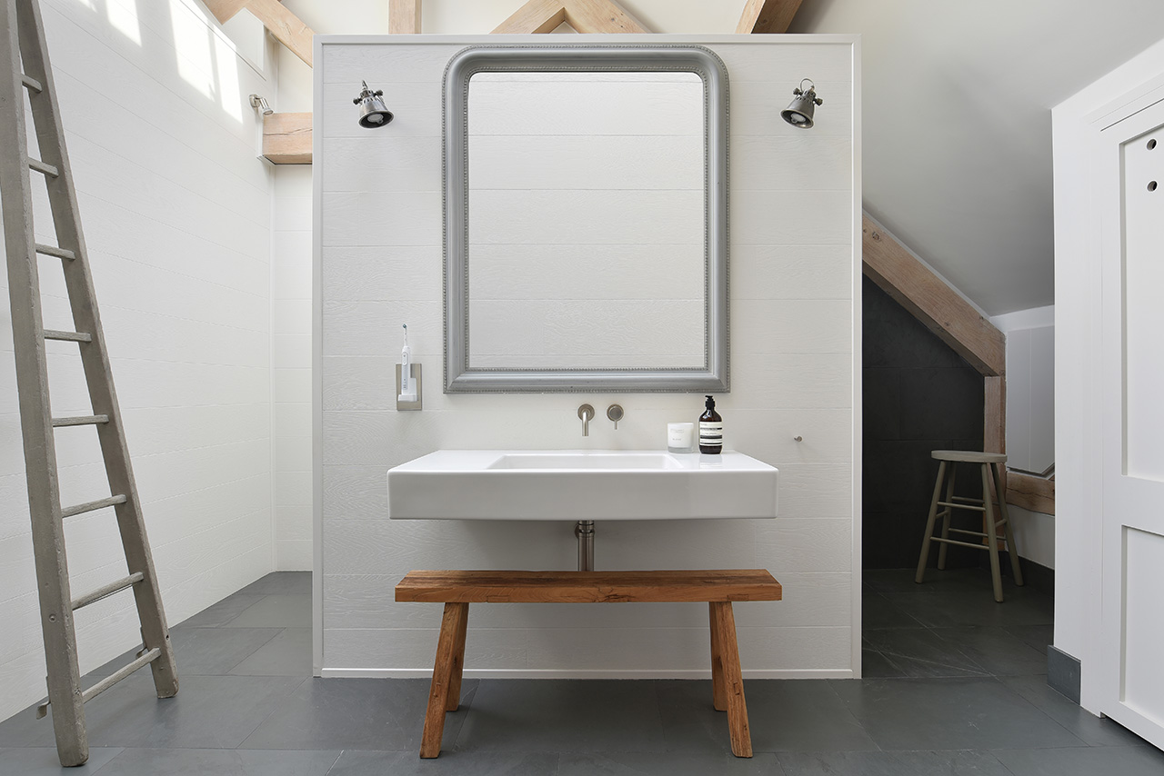 stunning white modern bathroom with wooden ladder photographed by London based Architectural Interior Photographer
